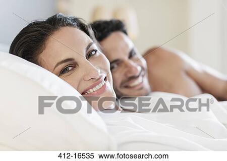 Close up portrait of happy couple in bed View Large Photo Image Stock Photography - Close up portrait of happy couple in bed. Fotosearch