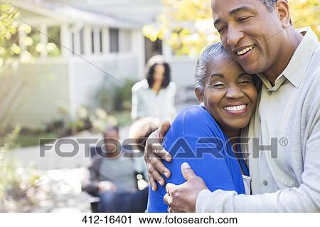 Close up portrait of happy senior couple hugging on patio View Large Photo Image Stock Image - Close up portrait of happy senior couple hugging on patio. Fotosearch