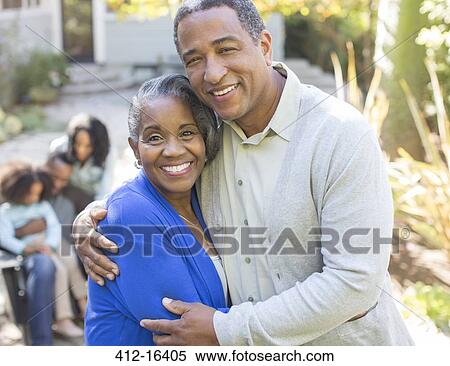 Stock Photography - Close up portrait of smiling senior couple hugging outdoors. Fotosearch