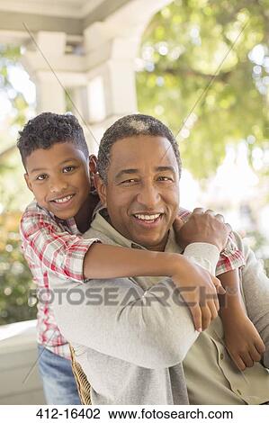 Close up portrait of smiling grandfather and grandson hugging on porch View Large Photo Image Stock Image - Close up portrait of smiling grandfather and grandson hugging on porch. Fotosearch