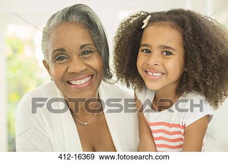 Close up portrait of smiling grandmother and granddaughter View Large Photo Image Stock Photo - Close up portrait of smiling grandmother and granddaughter. Fotosearch