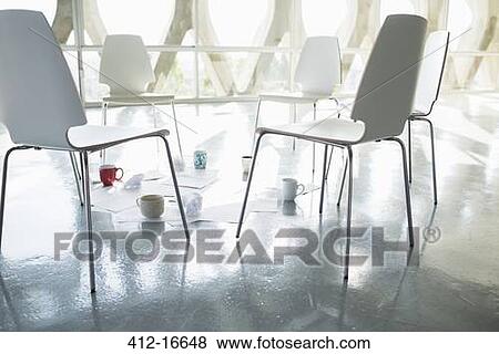 Coffee cups and paperwork at circle of chairs View Large Photo Image Stock Photo - Coffee cups and paperwork at circle of chairs. Fotosearch