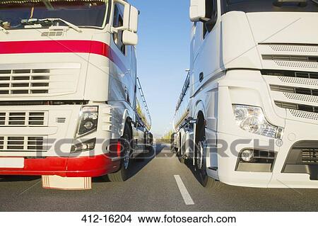 Picture - Commercial trucks side by side on the road. Fotosearch