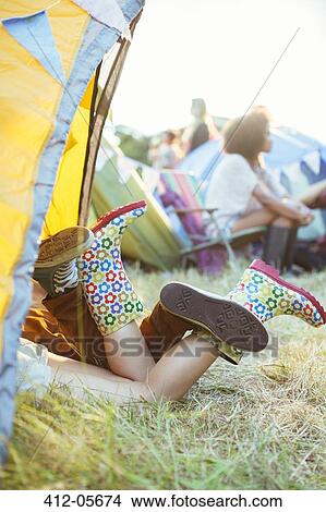 Couple's legs sticking out of tent at music festival View Large Photo Image Picture - Couple's legs sticking out of tent at music festival. Fotosearch