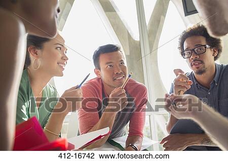 Stock Image - Creative business people brainstorming in circle. Fotosearch