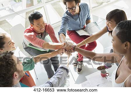 Creative business people connecting hands in huddle View Large Photo Image Stock Image - Creative business people connecting hands in huddle. Fotosearch