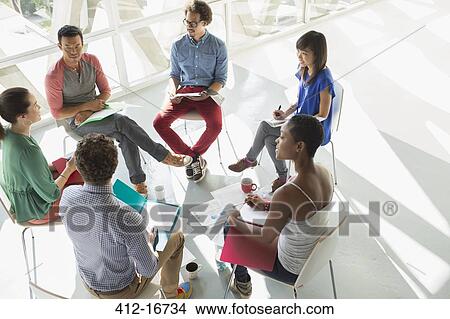 Picture - Creative business people meeting in circle of chairs. Fotosearch