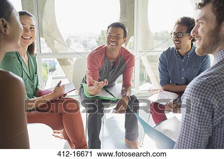 Stock Image - Creative business people meeting in circle of chairs. Fotosearch