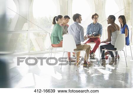 Creative business people meeting in circle of chairs View Large Photo Image Stock Photo - Creative business people meeting in circle of chairs. Fotosearch