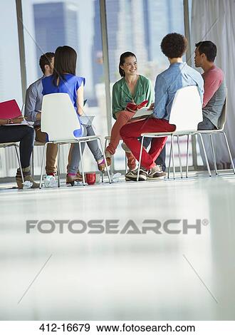 Creative business people meeting in circle of chairs View Large Photo Image Stock Photo - Creative business people meeting in circle of chairs. Fotosearch