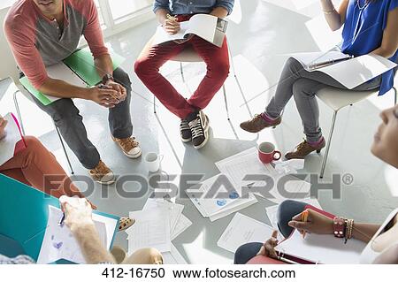 Creative business people meeting with coffee and paperwork in circle of chairs View Large Photo Image Stock Image - Creative business people meeting with coffee and paperwork in circle of chairs. Fotosearch