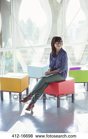 Creative businesswoman waiting on colorful stool View Large Photo Image Stock Photo - Creative businesswoman waiting on colorful stool. Fotosearch