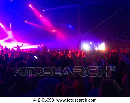 Crowd facing illuminated stage View Large Photo Image Stock Image - Crowd facing illuminated stage. Fotosearch