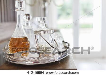 Crystal alcohol decanters on silver tray View Large Photo Image Picture - Crystal alcohol decanters on silver tray. Fotosearch