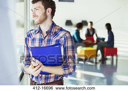 Distracted casual businessman looking out window outside meeting View Large Photo Image Stock Photograph - Distracted casual businessman looking out window outside meeting. Fotosearch
