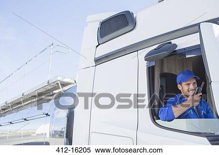 Driver using walkie-talkie in stainless steel milk tanker View Large Photo Image Stock Photography - Driver using walkie-talkie in stainless steel milk tanker. Fotosearch