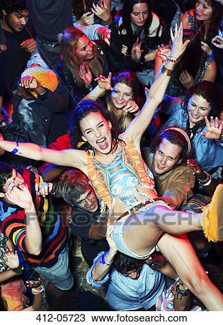 Enthusiastic woman crowd surfing at music festival View Large Photo Image Stock Image - Enthusiastic woman crowd surfing at music festival. Fotosearch