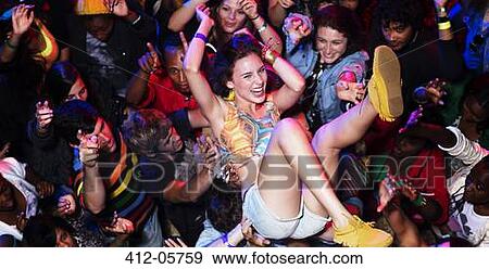 Enthusiastic woman crowd surfing at music festival View Large Photo Image Stock Photo - Enthusiastic woman crowd surfing at music festival. Fotosearch