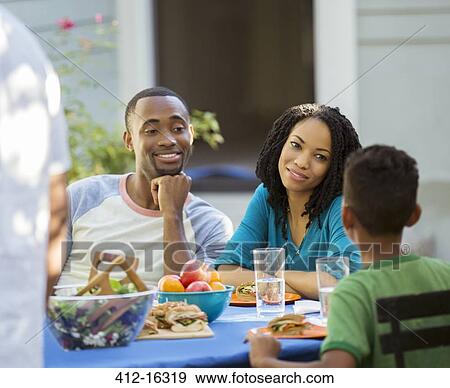 Family eating lunch at patio table View Large Photo Image Stock Photo - Family eating lunch at patio table. Fotosearch