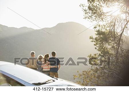 Family looking at mountain view outside car View Large Photo Image Stock Photo - Family looking at mountain view outside car. Fotosearch