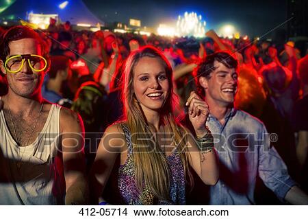 Fans dancing at music festival View Large Photo Image Picture - Fans dancing at music festival. Fotosearch