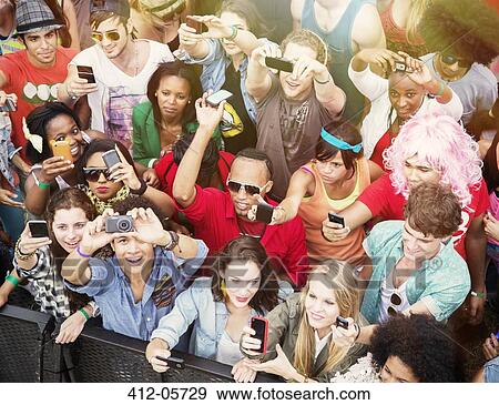Fans with camera phones cheering at music festival View Large Photo Image Stock Photo - Fans with camera phones cheering at music festival. Fotosearch
