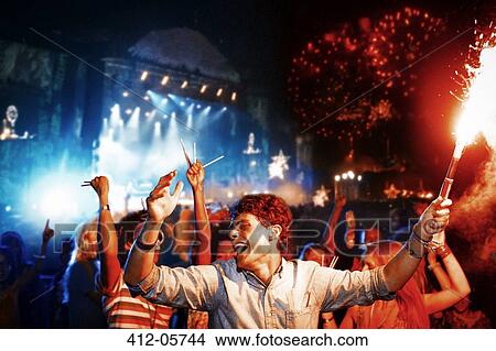 Fans with fireworks at music festival View Large Photo Image Picture - Fans with fireworks at music festival. Fotosearch