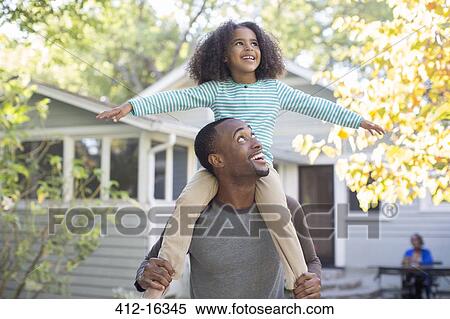 Father carrying happy daughter on shoulders View Large Photo Image Stock Photography - Father carrying happy daughter on shoulders. Fotosearch
