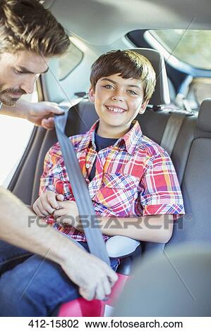 Father fastening seat belt for boy in back seat of car View Large Photo Image Stock Image - Father fastening seat belt for boy in back seat of car. Fotosearch