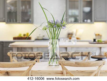Flowers in vase on wooden table View Large Photo Image Stock Photograph - Flowers in vase on wooden table. Fotosearch