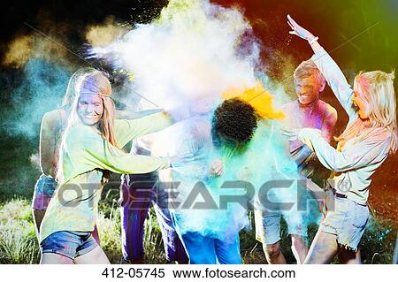 Friends throwing chalk dye on man at music festival View Large Photo Image Stock Photography - Friends throwing chalk dye on man at music festival. Fotosearch