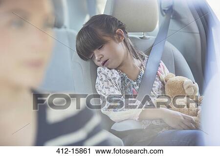 Girl with teddy bear sleeping in back seat of car View Large Photo Image Stock Image - Girl with teddy bear sleeping in back seat of car. Fotosearch