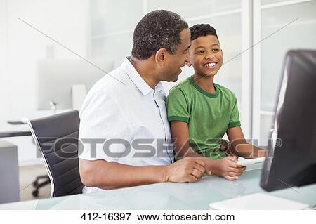 Grandfather and grandson using computer View Large Photo Image Stock Photo - Grandfather and grandson using computer. Fotosearch