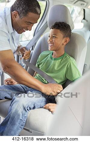 Grandfather fastening grandson's seat belt in back seat of car View Large Photo Image Stock Photo - Grandfather fastening grandson's seat belt in back seat of car. Fotosearch