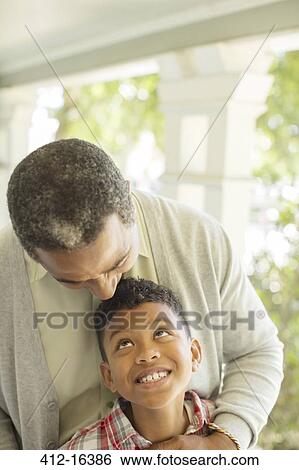 Grandfather hugging grandson on porch View Large Photo Image Stock Photograph - Grandfather hugging grandson on porch. Fotosearch