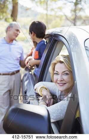 Grandparents and grandchildren inside and outside car View Large Photo Image Stock Image - Grandparents and grandchildren inside and outside car. Fotosearch