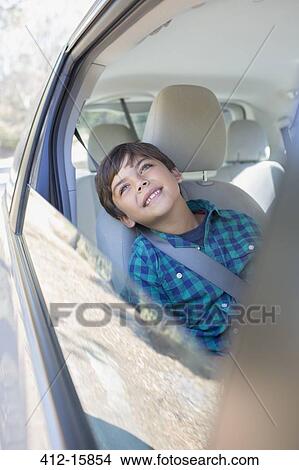 Happy boy looking out car window View Large Photo Image Picture - Happy boy looking out car window. Fotosearch