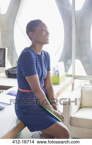 Happy businesswoman in office View Large Photo Image Picture - Happy businesswoman in office. Fotosearch