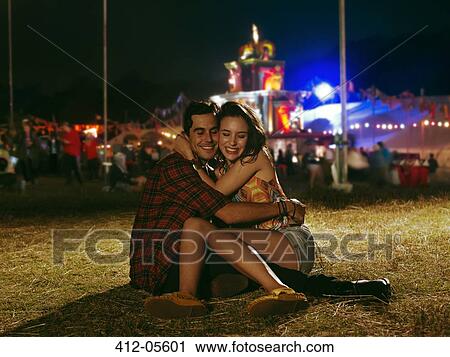Happy couple hugging outside music festival View Large Photo Image Stock Image - Happy couple hugging outside music festival. Fotosearch
