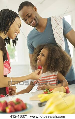 Happy family eating strawberries View Large Photo Image Stock Image - Happy family eating strawberries. Fotosearch