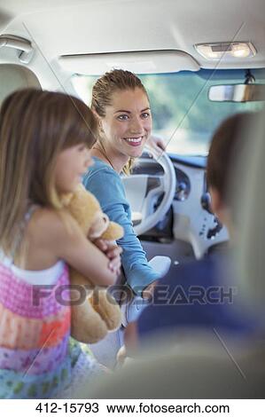 Stock Image - Happy family inside car. Fotosearch