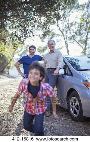 Happy multi-generation men outside car View Large Photo Image Stock Photograph - Happy multi-generation men outside car. Fotosearch