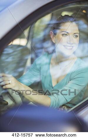 Happy woman driving car View Large Photo Image Stock Photo - Happy woman driving car. Fotosearch