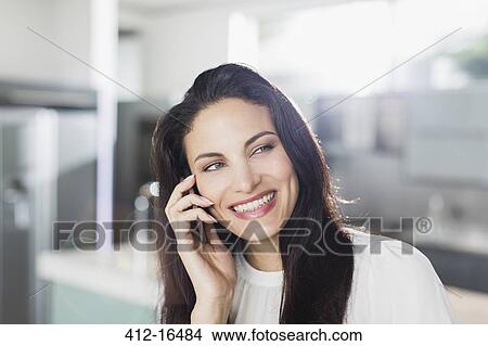 Happy woman talking on cell phone View Large Photo Image Picture - Happy woman talking on cell phone. Fotosearch