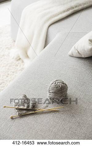 Knitting needles and ball of wool on sofa View Large Photo Image Stock Image - Knitting needles and ball of wool on sofa. Fotosearch