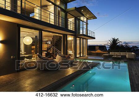 Luxury house with swimming pool illuminated at night View Large Photo Image Stock Image - Luxury house with swimming pool illuminated at night. Fotosearch