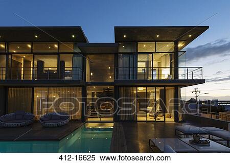 Luxury house with swimming pool illuminated at night View Large Photo Image Stock Photography - Luxury house with swimming pool illuminated at night. Fotosearch