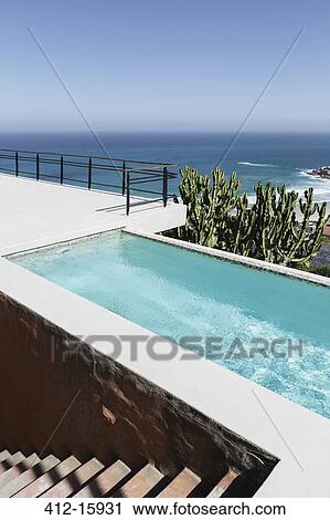 Luxury lap pool overlooking ocean View Large Photo Image Stock Image - Luxury lap pool overlooking ocean. Fotosearch