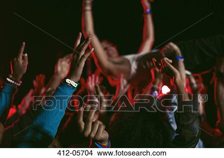 Man crowd surfing at music festival View Large Photo Image Picture - Man crowd surfing at music festival. Fotosearch