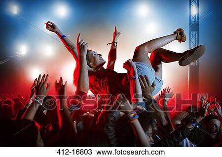 Man crowd surfing at music festival View Large Photo Image Stock Image - Man crowd surfing at music festival. Fotosearch